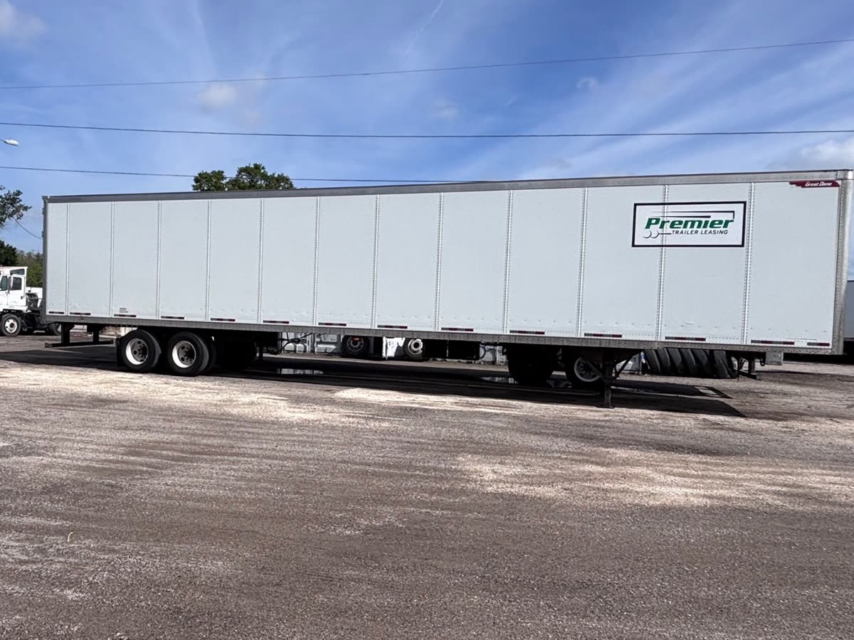 Clean white 53-foot dry van after semi trailer decal removal and adhesive removal, with only the leasing company logo remaining