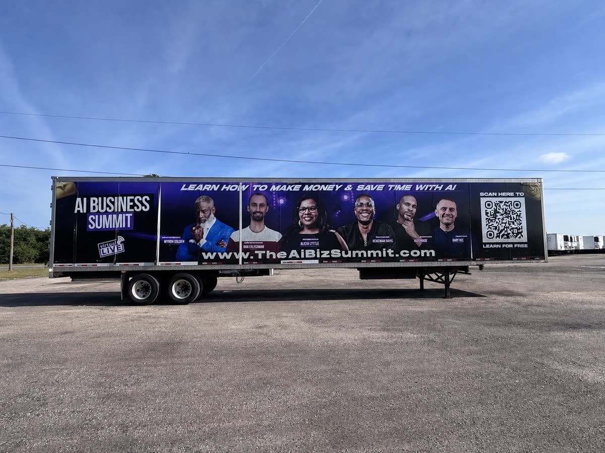 53-foot dry van fully wrapped in a dark advertising graphic before commercial trailer decal removal