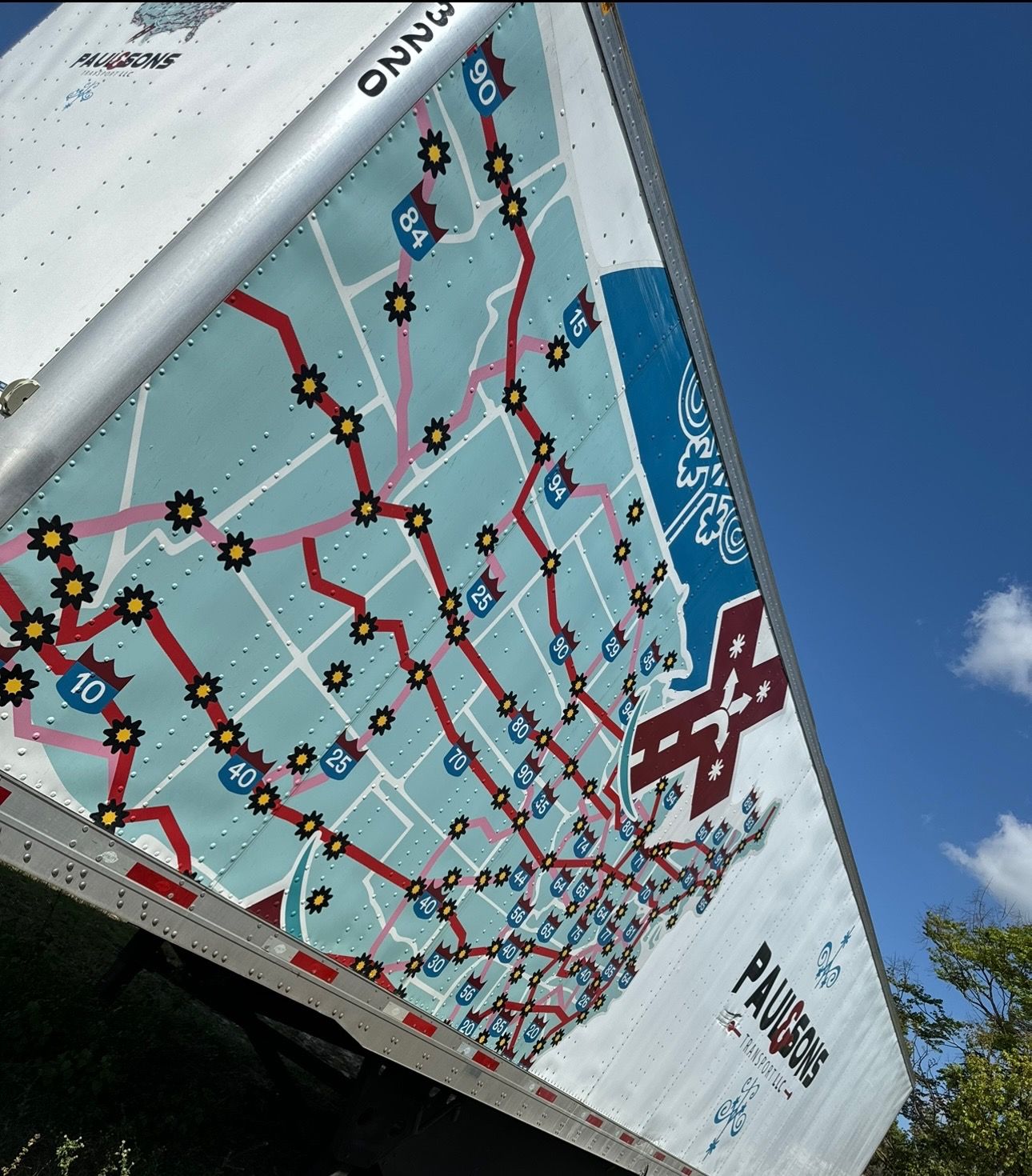 Dry van side panel covered by a large printed map graphic before removal